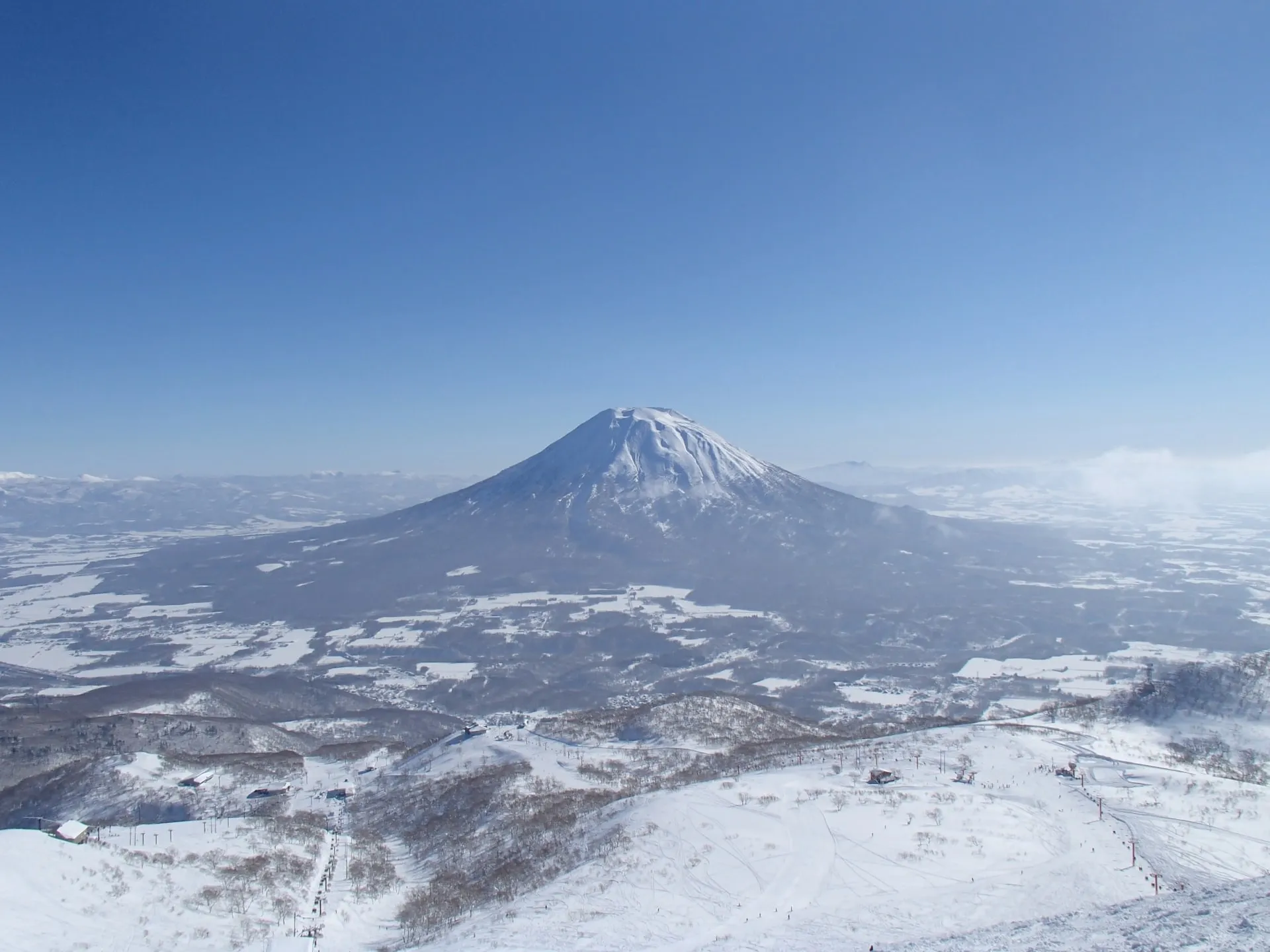 Mount Yotei rising snow-covered above the Niseko valley under a clear winter sky