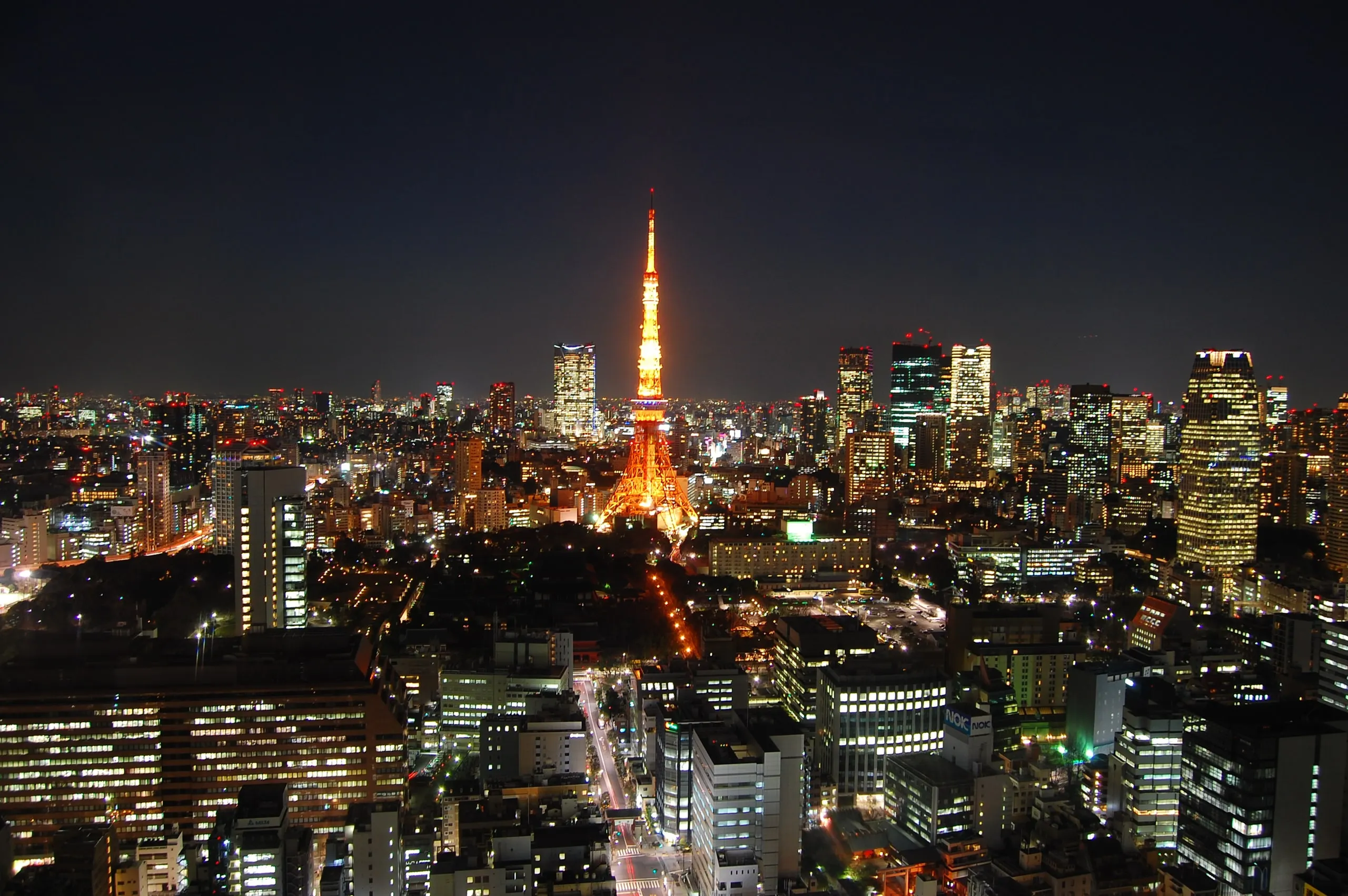 The Tokyo skyline at night, Tokyo Tower glowing at its centre among lit residential towers